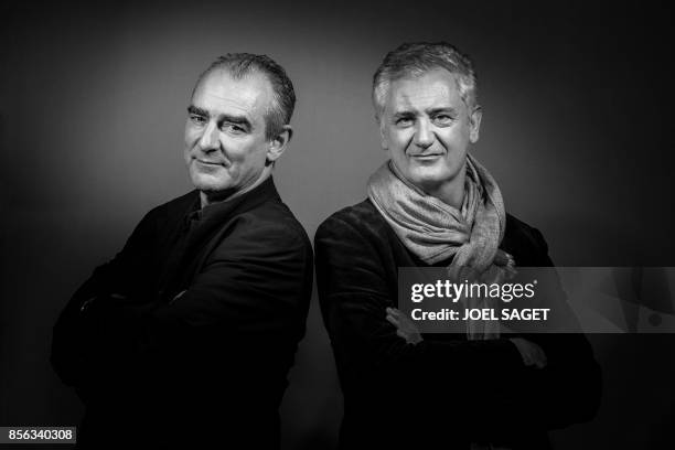 Belgian comic book artist Philippe Francq and French writer Eric Giacometti, authors of the serie Largo Winch, pose during a photo session in Paris,...