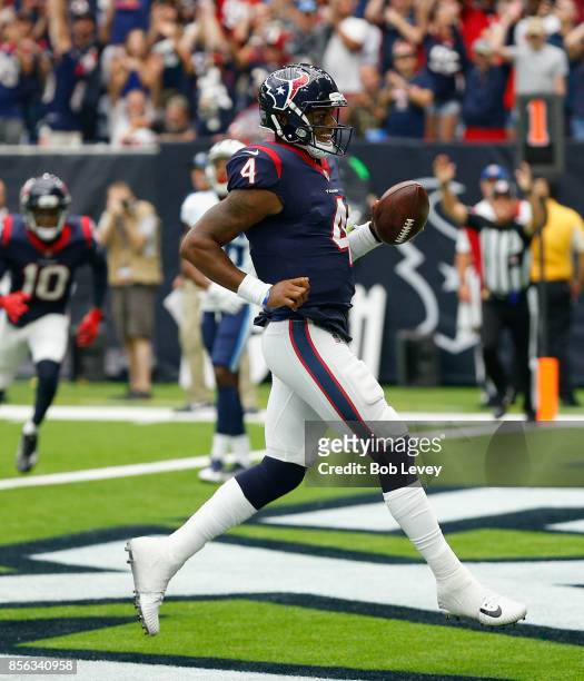Deshaun Watson of the Houston Texans runs for a one yard touchdown in the second quarter against the Tennessee Titans at NRG Stadium on October 1,...