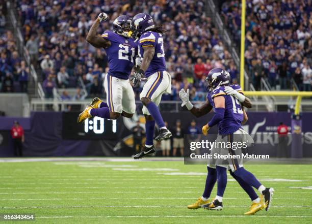Dalvin Cook of the Minnesota Vikings and teammate Jerick McKinnon celebrate a touchdown in the second quarter against the Detroit Lions game on...