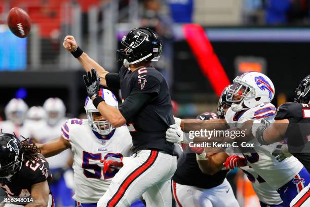 Matt Ryan of the Atlanta Falcons fumbles after being hit by Jerry Hughes of the Buffalo Bills during the second half at Mercedes-Benz Stadium on...