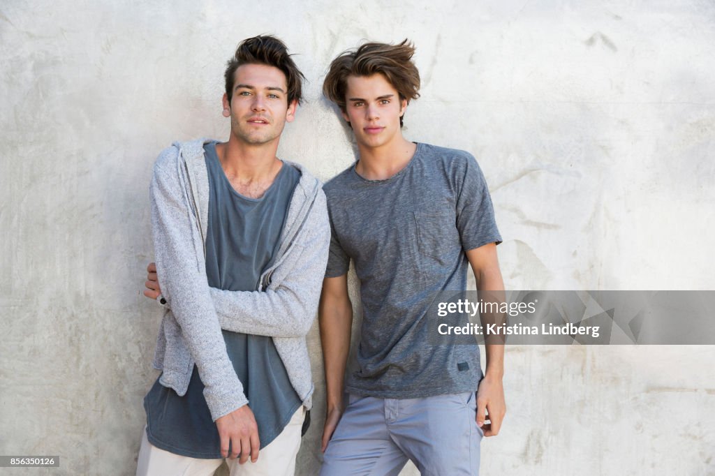 Teenage/ young adult friends portraits by a grey wall