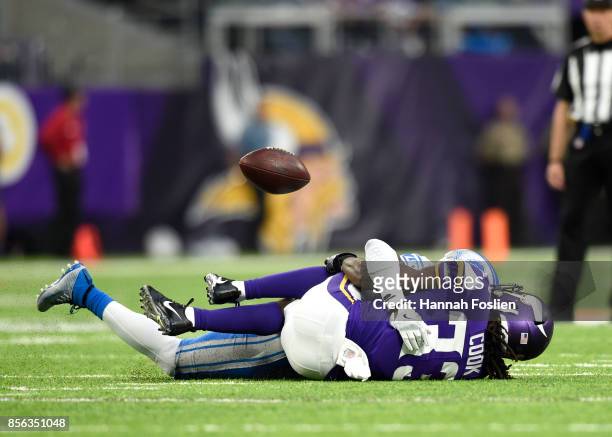 Dalvin Cook of the Minnesota Vikings grabs his knee after fumbling the ball while being tackled by defender Tavon Wilson of the Detroit Lions in the...
