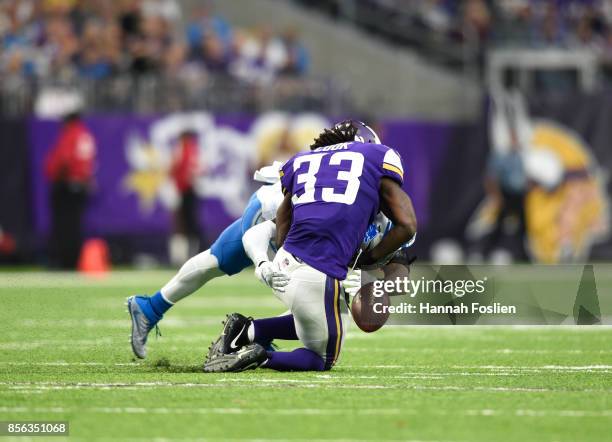 Dalvin Cook of the Minnesota Vikings fumbles the ball while being tackled by defender Tavon Wilson of the Detroit Lions in the third quarter of the...