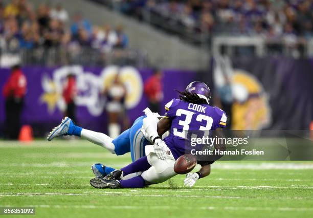 Dalvin Cook of the Minnesota Vikings fumbles the ball while being tackled by defender Tavon Wilson of the Detroit Lions in the third quarter of the...