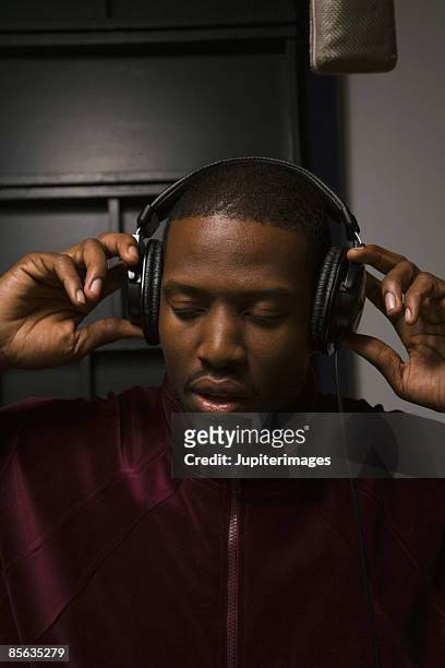 singer with headphones in recording studio - mike glad stockfoto's en -beelden