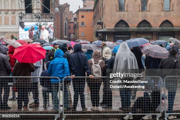 People attend under the rain the pastoral visit of Pope Francis on October 1, 2017 in Bologna, Italy. Pope Francis visits Bologna for the first time...