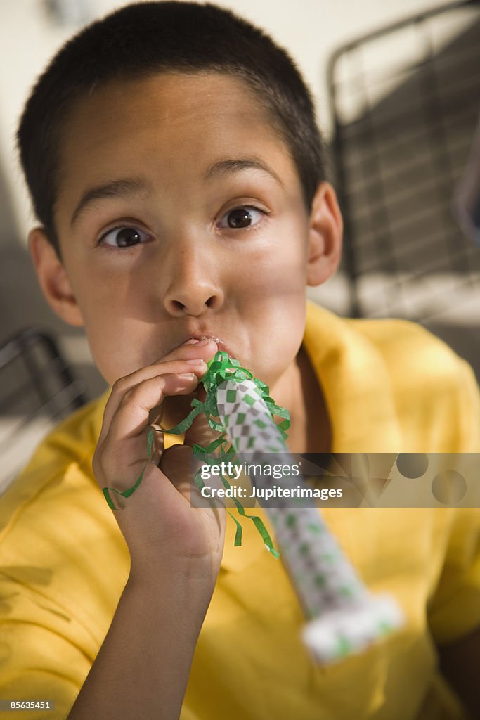 Boy with a party noise maker