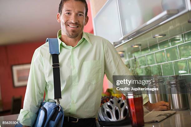 man with shoulder bag and bike helmet - borsa messenger foto e immagini stock