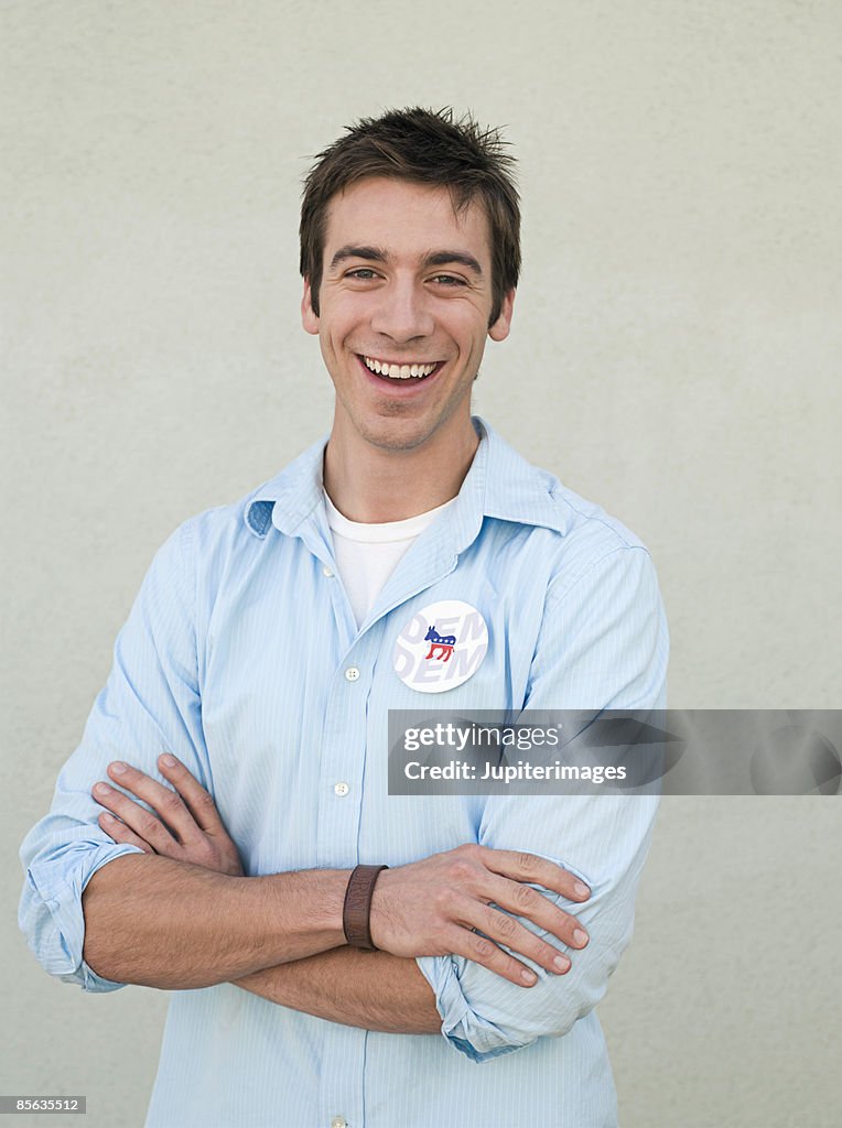 Laughing man wearing vote button