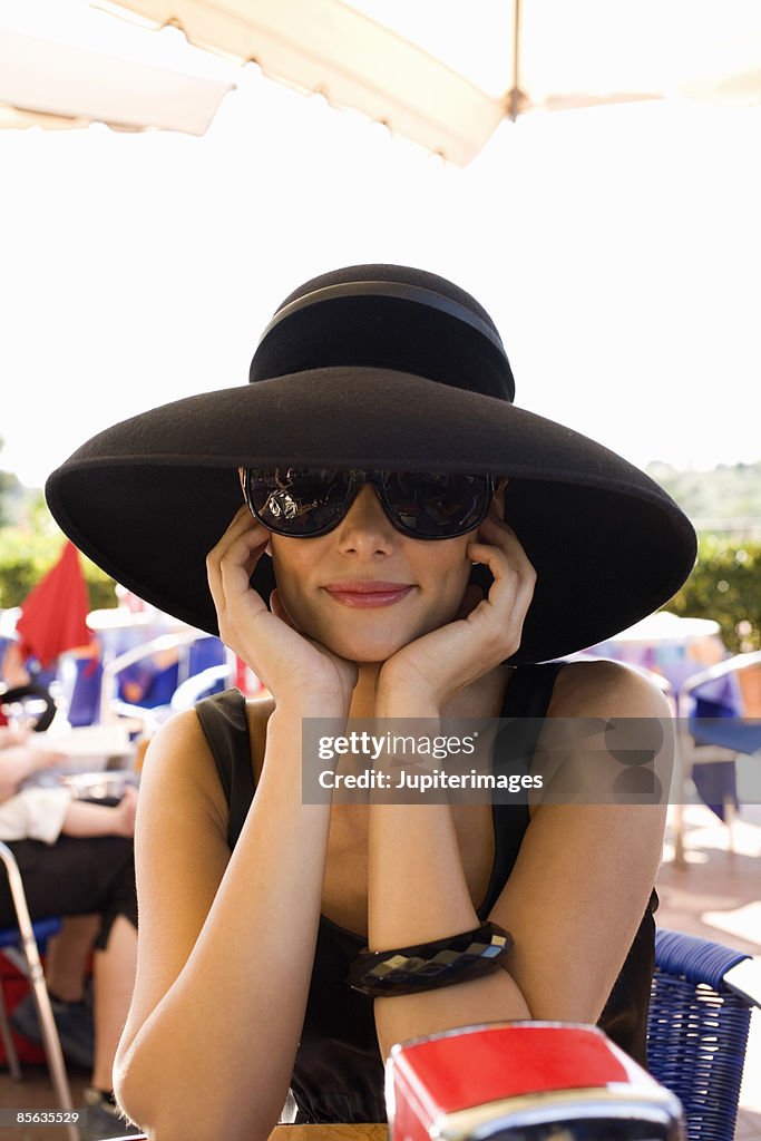 Woman in black hat at outdoor cafe, Florence, Italy