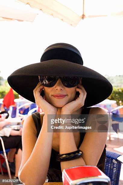 woman in black hat at outdoor cafe, florence, italy - sunglasses disguise bildbanksfoton och bilder