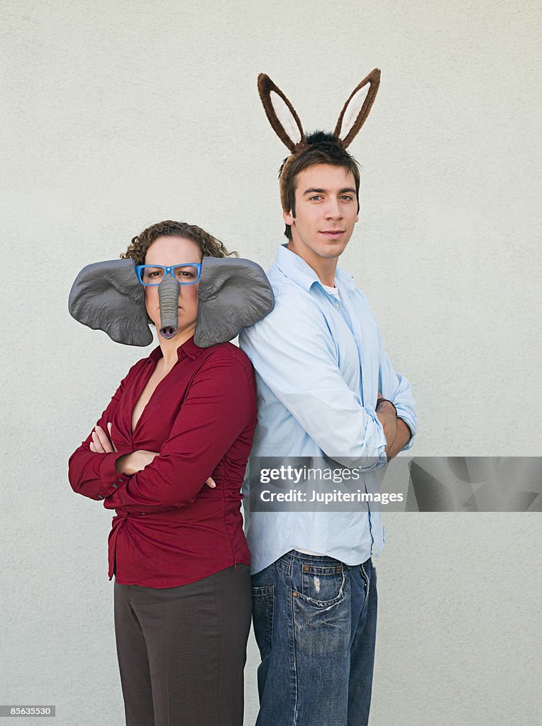 Man and woman wearing donkey and elephant ears