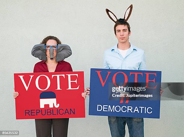 democratic and republican activists with costumes and signs - republican democrat donkey elephant stock pictures, royalty-free photos & images