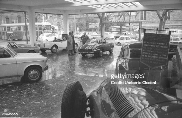 Rome an Alfa Romeo cars showroom with a red Giulietta Sprint Speciale and a white Giulia Spider