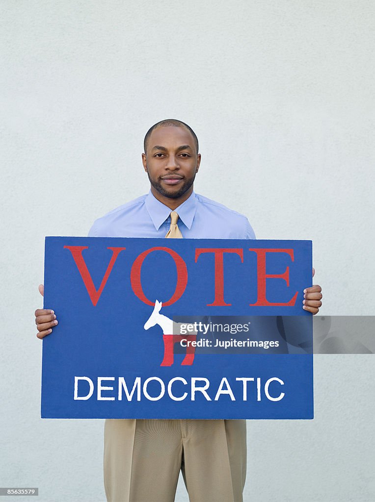 Man holding political sign