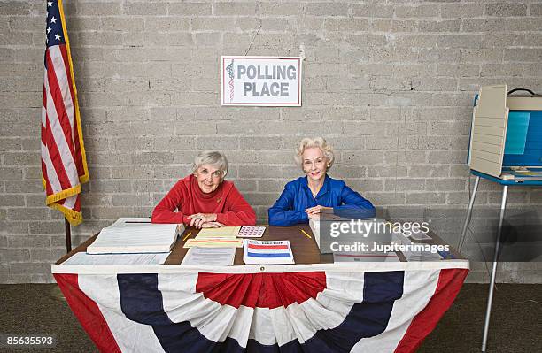 senior women at polling place table - polling station us stock pictures, royalty-free photos & images