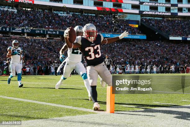 Dion Lewis of the New England Patriots scores a touchdown during the fourth quarter against the Carolina Panthers at Gillette Stadium on October 1,...