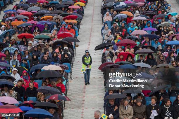 Volunteer under the rain attend a holy mass at the Renato Dall'Ara Stadium during a pastoral visit of Pope Francis on October 1, 2017 in Bologna,...