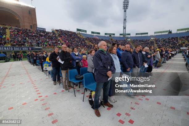 People attend under the rain a holy mass at the Renato Dall'Ara Stadium during a pastoral visit of Pope Francis on October 1, 2017 in Bologna, Italy....