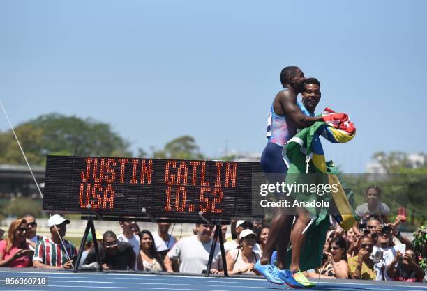 Justin Gatlin and Brazilian sprinter Paulo André de Oliveira celebrate after the 'Mano a Mano Athletics Challenge' at the Brazilian Jockey Club on...