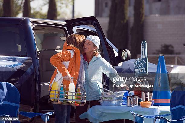 friends hugging at tailgate party - tailgate stock pictures, royalty-free photos & images