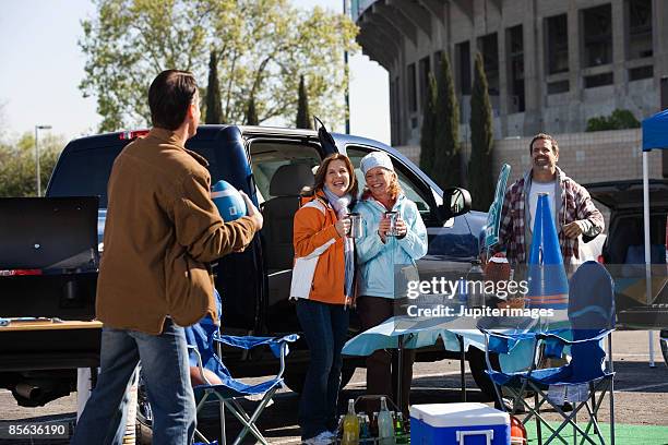 group of friends smiling at tailgate party - tailgate stock pictures, royalty-free photos & images