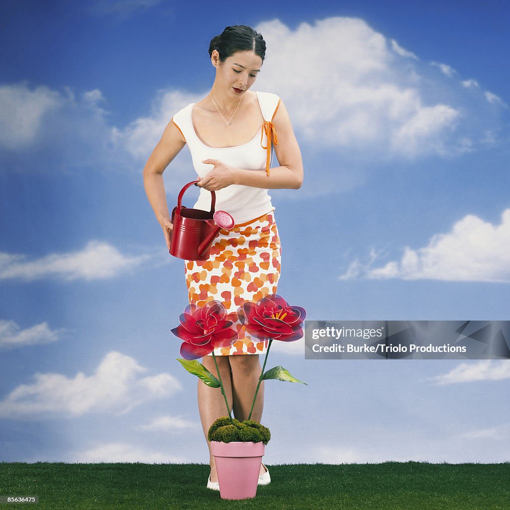 Woman watering potted flowers