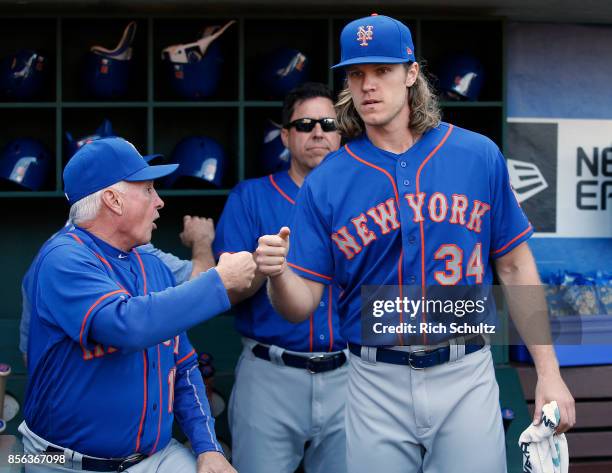 Manager Terry Collins of the New York Mets fist bumps pitcher Noah Syndergaard before the start of a game against the Philadelphia Phillies at...