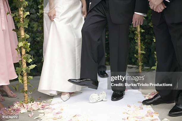 groom stepping on glass during jewish wedding ceremony - jewish wedding ceremony stock pictures, royalty-free photos & images