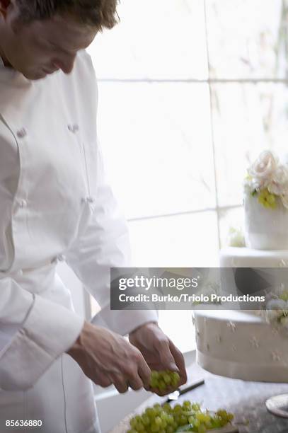 man decorating wedding cake - wedding cake baker stock pictures, royalty-free photos & images
