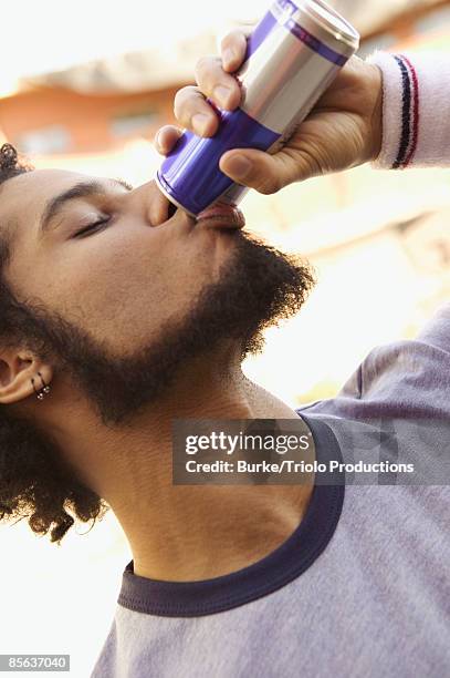 man drinking energy drink - energydrink stock-fotos und bilder