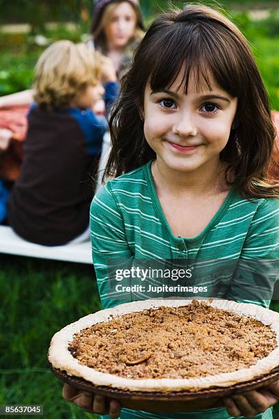 smiling girl holding pie - apple pie stock pictures, royalty-free photos & images