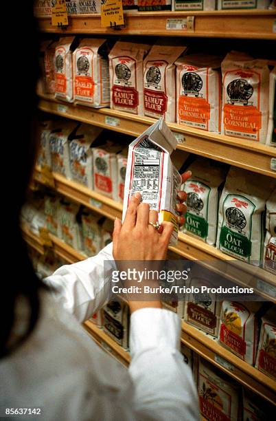 woman reading a label - nutritional information stock pictures, royalty-free photos & images