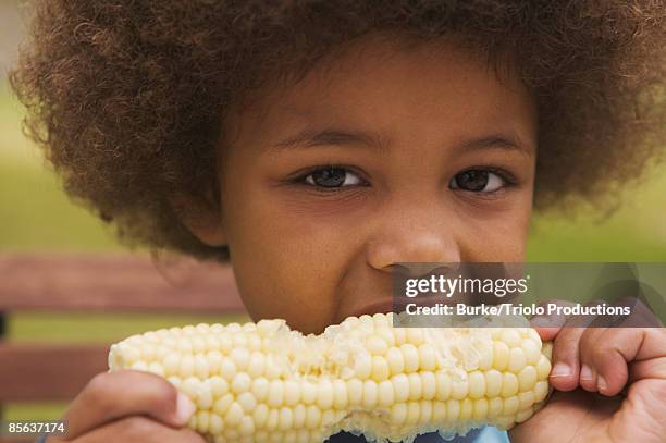 boy eating sweet corn - sweetcorn stock pictures, royalty-free photos & images