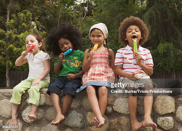 kids eating ice-pops - ice lolly stock pictures, royalty-free photos & images