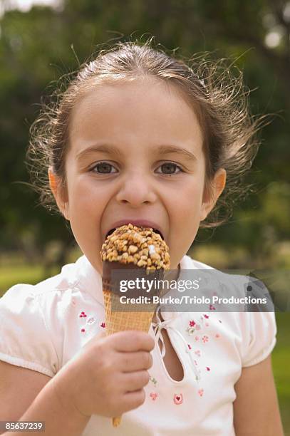 girl eating ice cream cone - drumstick stock pictures, royalty-free photos & images