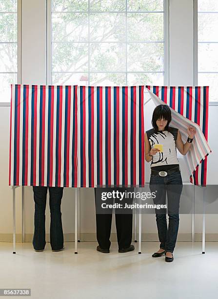 hipster emerging from voting booth - election day stock pictures, royalty-free photos & images