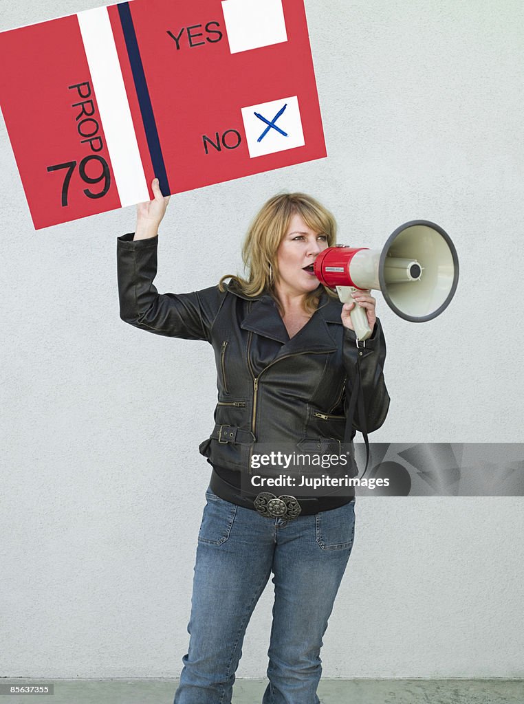 Political activist with sign and bullhorn