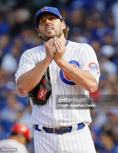 John Lackey of the Chicago Cubs rubs the ball after giving up a run in the 4th inning against the Cincinnati Reds at Wrigley Field on October 1, 2017...