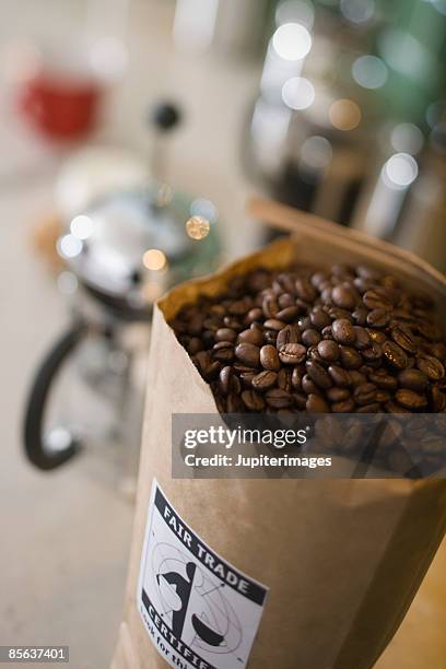 bag of coffee beans with coffee maker - fair trade stock pictures, royalty-free photos & images