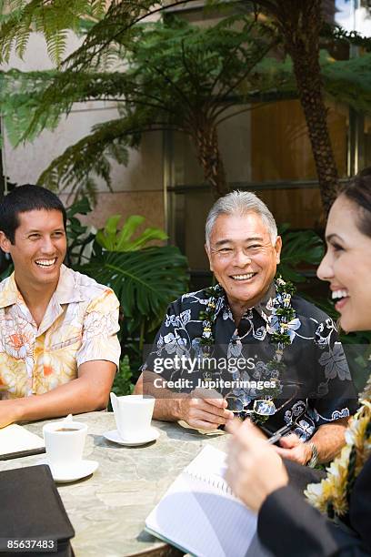 men laughing with businesswoman - lei day hawaii stock pictures, royalty-free photos & images