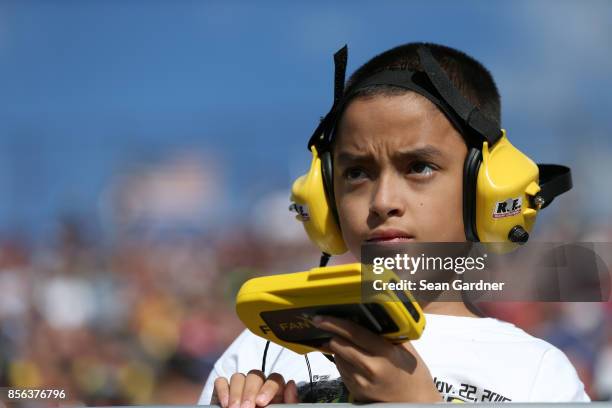 Young race fan looks on during the Monster Energy NASCAR Cup Series Apache Warrior 400 presented by Lucas Oil at Dover International Speedway on...