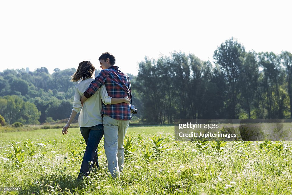 Couple walking in field