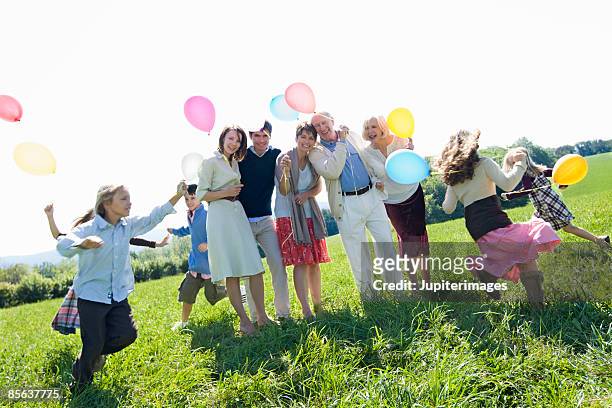 family reunion portrait - kids party balloons stock-fotos und bilder