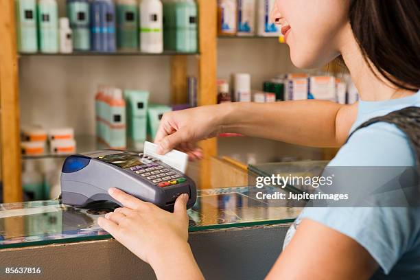 woman using credit card at store - cosmetics counter stock pictures, royalty-free photos & images