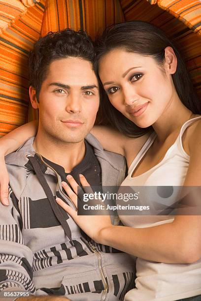 couple sitting in egg chair - egg chair stockfoto's en -beelden