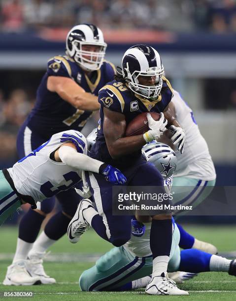 Todd Gurley of the Los Angeles Rams runs the ball past Jeff Heath and Brian Price of the Dallas Cowboys in the third quarter at AT&T Stadium on...