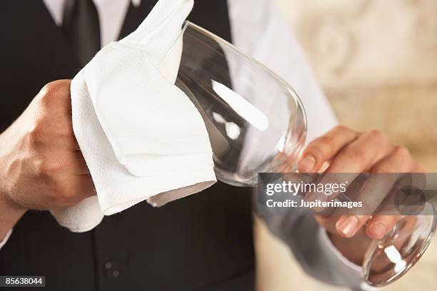 waiter cleaning wineglass - camarero fotografías e imágenes de stock