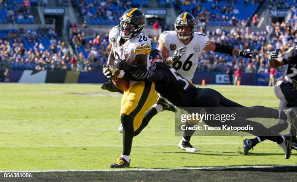 Le'Veon Bell of the Pittsburgh Steelers scores a touchdown as C.J. Mosley of the Baltimore Ravens tries to stop him in the fourth quarter at M&T Bank...