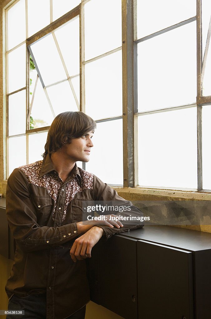 Man looking out of window